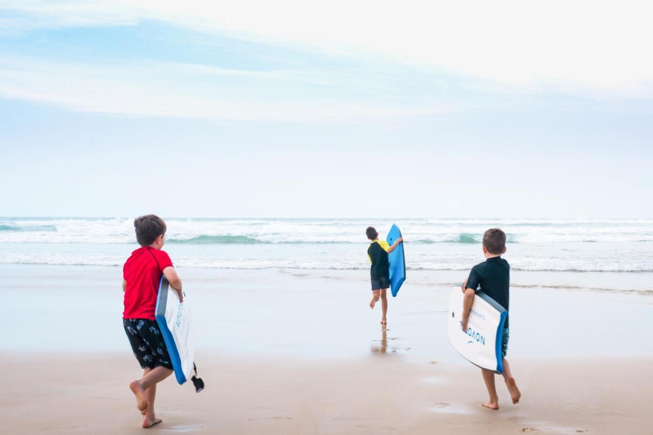 Novotel Chennai Sipcot Exterior foto Children learning to surf at the beach